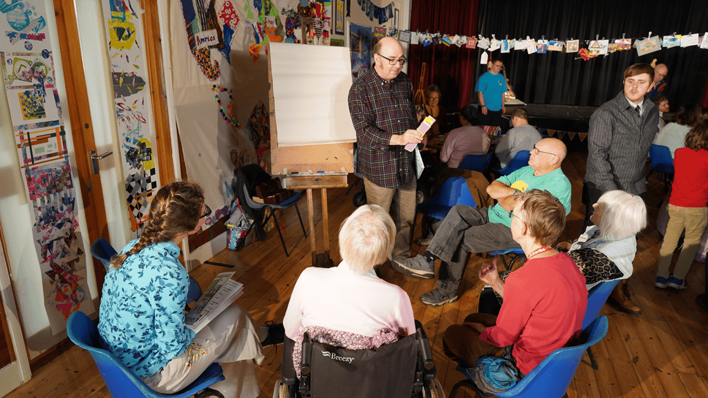 suffolk artlink workshop members gathered for an art instruction